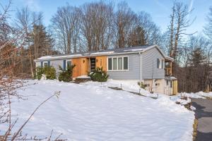 a home in the snow in the woods at Charming Retreat Walking in Tannersville