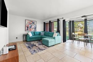 a living room with a blue couch and a table at Surf N Snooze-Central Destin-Pet Friendly in Destin
