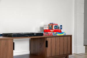 a table with a pile of toys on top of it at Surf N Snooze-Central Destin-Pet Friendly in Destin