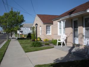 a white chair sitting on the front porch of a house at Two-Bedroom Wildwood Crest Condo in Wildwood Crest