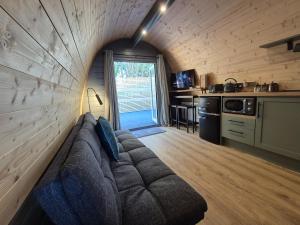 a living room with a couch in a kitchen at Little Abrach Pod in Inverlochy