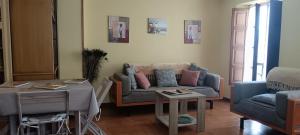 a living room with a couch and a table at Duplex Luarca in Luarca