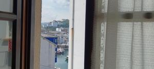a window with a view of a river and buildings at Duplex Luarca in Luarca