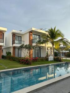 a house with a swimming pool in front of a house at Biệt thự nghỉ dưỡng Saint Simeon Long Hải in Ấp Phước Tĩnh