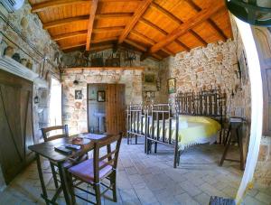 a bedroom with a bed and a table and chairs at B&B Pergulea in Sternatia +55 photos