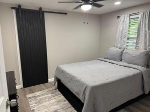 a bedroom with a bed and a ceiling fan at Mae's Place in Savannah