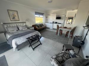 a bedroom with a bed and a living room at 14 at Karee in Stilbaai