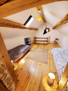 a attic bedroom with two beds and wooden floors at Moulin de Boudelogne in Villard +9 photos