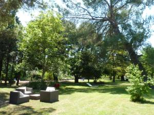 a park with couches sitting in the grass at Domaine de Rhodes - 5 Chambres et 7 locations de vacances in Avignon +39 photos