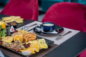 a table with a plate of food and a cup of coffee at Hotel Rias Dakhla & Restaurant in Dakhla