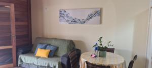 a living room with a table and a chair at Casa aconchego perto da praia in Guaratuba