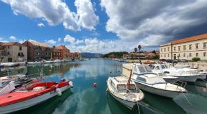 a group of boats are docked in a harbor at Stone house Zora in Stari Grad