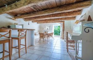 a kitchen and dining room with a table and chairs at Hameau de l'Esperelle in Simiane-la-Rotonde +16 photos