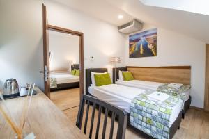 a small room with a bed and a table at Anna Vendégház in Visegrád