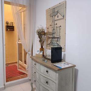 a dresser with a computer on top of it next to a door at Escapada junto a Picasso in Málaga +14 photos