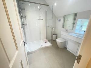 a bathroom with a shower and a toilet and a sink at Rural Coastal Self-Catering Accommodation for 8, Near Sandringham Estate, Norfolk in Ingoldisthorpe +27 photos
