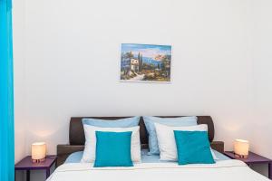 a bedroom with a bed with blue and white pillows at Apartments Tina in Split