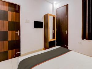 Postel nebo postele na pokoji v ubytování Collection O Kiara Guest House