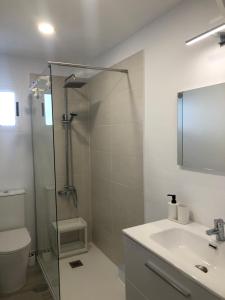 a bathroom with a shower and a toilet and a sink at Casa Yolanda in Tías +15 photos