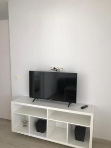 a white entertainment center with a flat screen tv at Casa Yolanda in Tías