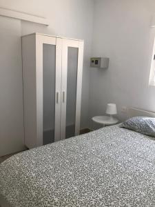 a bedroom with a bed and a white cabinet at Casa Yolanda in Tías