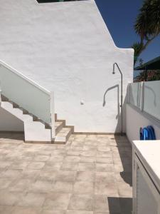 a staircase leading up to a white house with a tile floor at Casa Yolanda in Tías