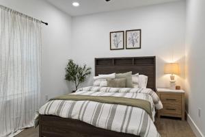 a white bedroom with a large bed and a window at Lake Hartwell Escape!- Cabin for groups & families in Westminster