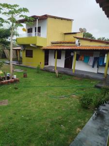 a house with a green hose in the yard at Tô em Casa Hospedagem 2 in Jijoca de Jericoacoara +13 photos