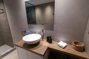 a bathroom with a sink and a mirror at Aurora Apart, 4 - Sea view suites near the beach in Marmari +24 photos