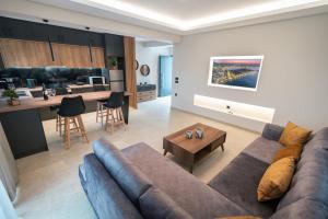 a living room with a couch and a kitchen at Aurora Apart, 4 - Sea view suites near the beach in Marmari