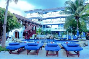 a resort with blue chairs and a swimming pool at Best Western Jangwani Sea Breeze Resort in Dar es Salaam