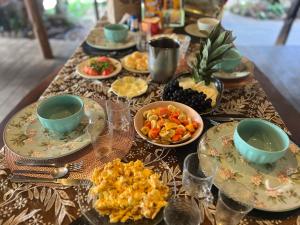 a table with plates and bowls of food on it at TerrAmor Ecoliving in Alter do Chao
