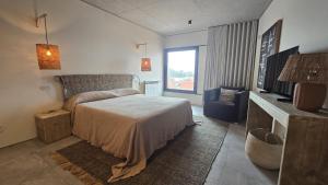 a bedroom with a bed and a television in it at Villa São Roque in Ponta Delgada +42 photos