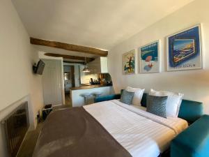 a bedroom with a large bed and a blue couch at Menton - SABLETTES BEACH VIEW in Menton