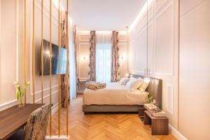 a hotel room with a bed and a table at VILLA MADRE Suites e Private Spa in Grottaferrata