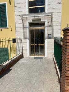 a door to a building with a fence at Begonia Apartment in Rome