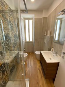 a bathroom with a shower and a sink at Begonia Apartment in Rome +8 photos