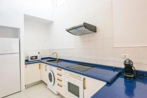 a kitchen with a sink and a refrigerator at Bungalow Golf del Sur in San Miguel de Abona