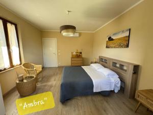a bedroom with a large bed and a table at Tuscany Hills - Comfort 10 minutes from Montepulciano and Pienza in Torrita di Siena +38 photos