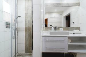 a white bathroom with a sink and a shower at Serce Pienin in Jaworki +12 photos