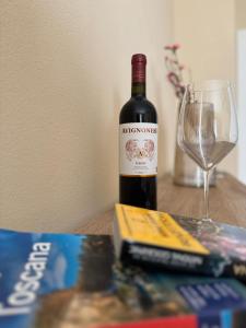 a bottle of wine and a glass on a table at Tuscany Hills - Comfort 10 minutes from Montepulciano and Pienza in Torrita di Siena