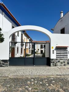 an arched garage door on a white house at Alqueva - Casa Da Luz in Mourão +45 photos