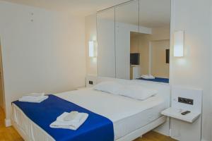 a bedroom with a bed with a large mirror at Room number 2046 in Batumi