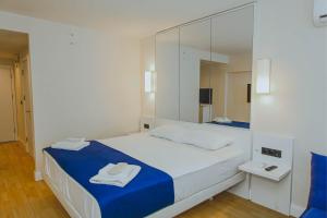 a bedroom with a bed with a large mirror at Room number 2046 in Batumi