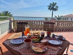 a table with plates of food on a balcony at Atico la piramide en primera 1º línea de mar in Vinarós