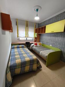 a bedroom with two beds in a room at Casa O Con in O Grove