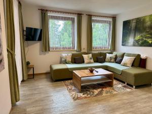 a living room with a couch and a coffee table at Ferienwohnung Petritz in Velden am Wörthersee