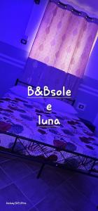 a bed with the words bebia a liao on it at B&B SOLE e LUNA in Pontecagnano