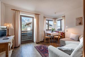 a living room with a couch and a table at Haus Alpin in Ellmau