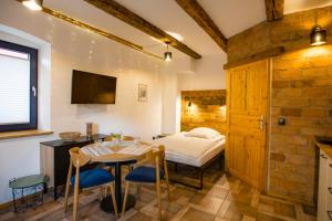 a bedroom with a bed and a table and chairs at Las Skarpa apartamenty in Srebrna Góra